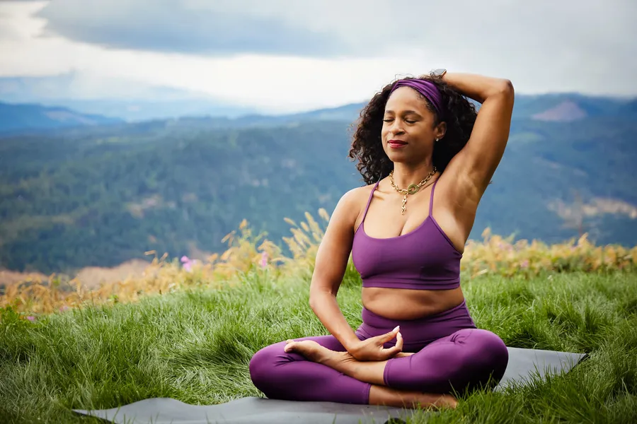 Ardie seated cross-legged, at ease, overlooking the Columbia River Gorge