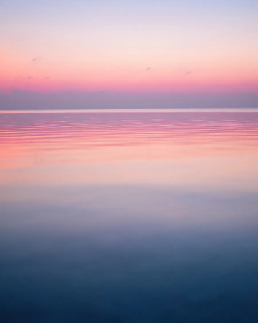Pastel sky over calm ocean water